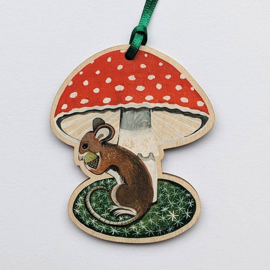 Wooden ornament with a red mushroom and a squirrel on a white background