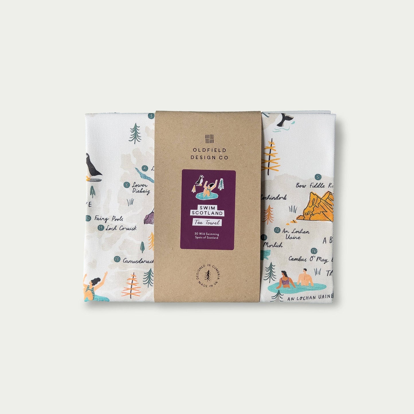 Packaged and folded 'Swim Scotland' tea towel on white background