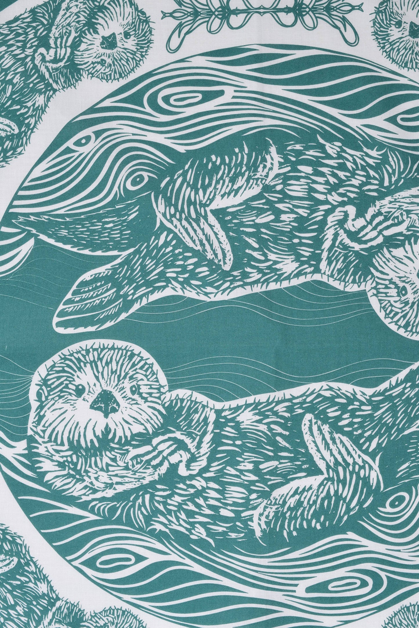 Pattern of otters and sea creatures on a teal background