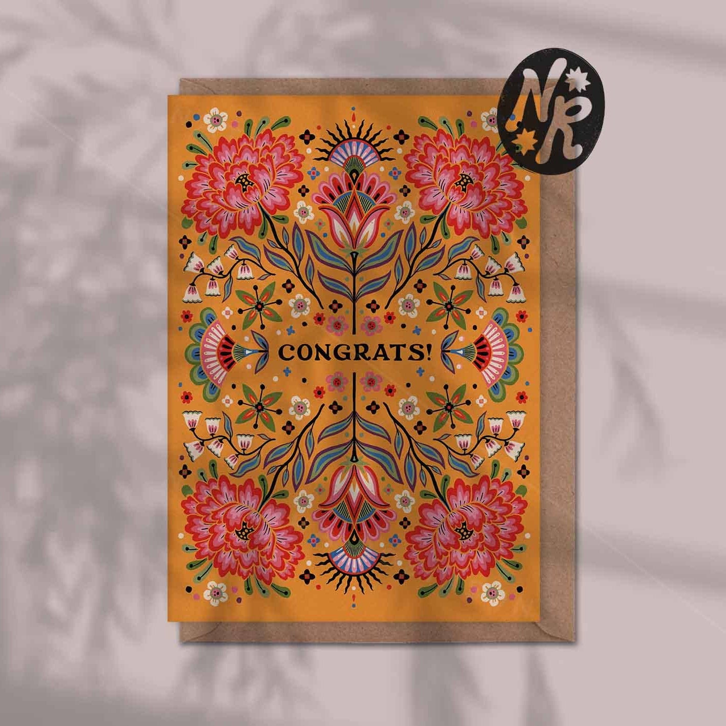 Decorative greeting card with floral design and 'Congrats!' text on an orange floral background.