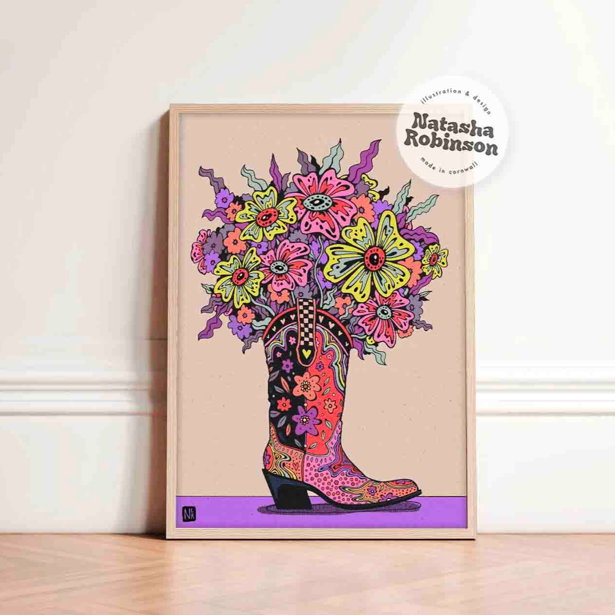 An art print featuring a colorful psychedelic inspired illustration of a boot with a bouquet of flowers, signed by Natasha Robinson.