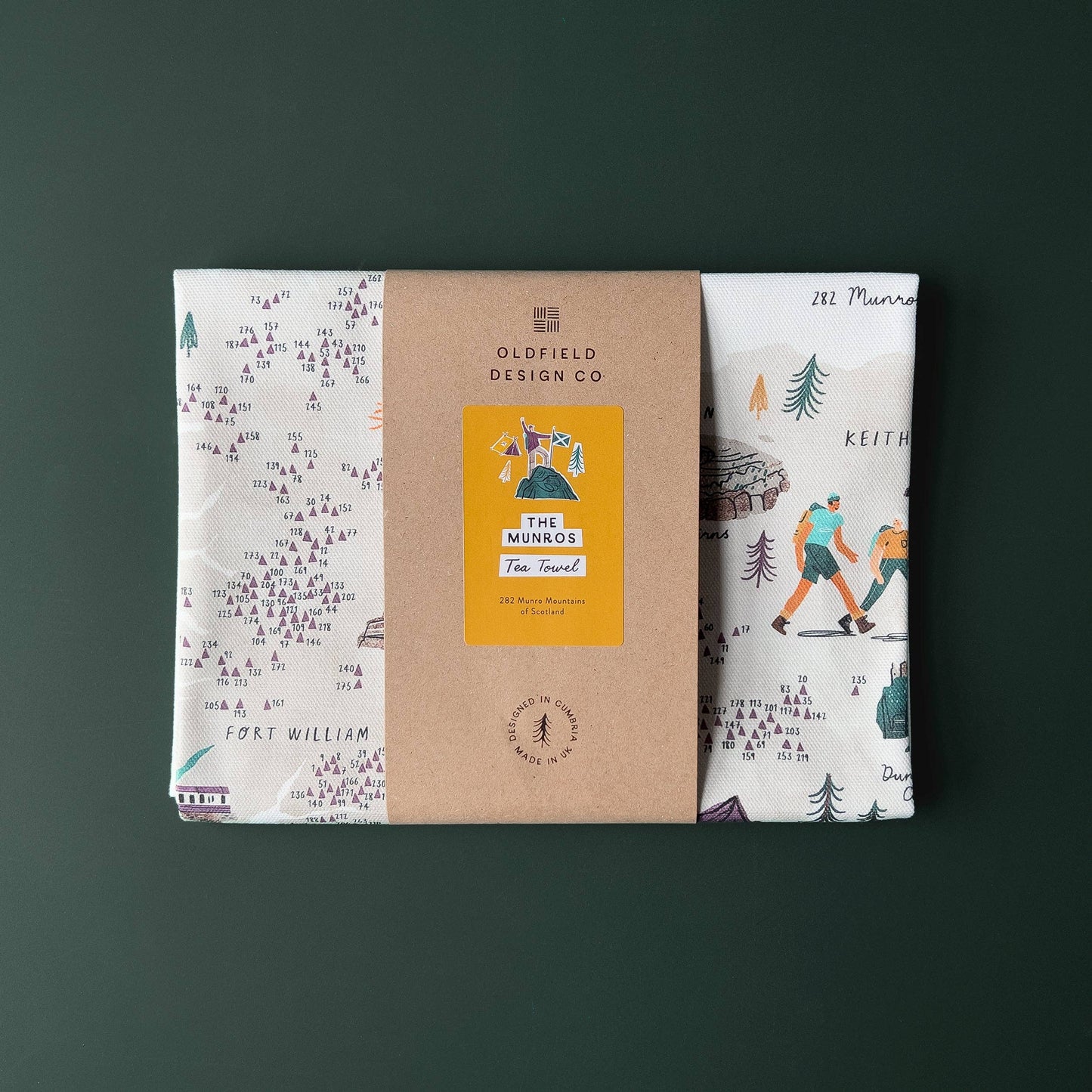 Illustrated tea towel showing the Munros of Scotland, folded and packaged.