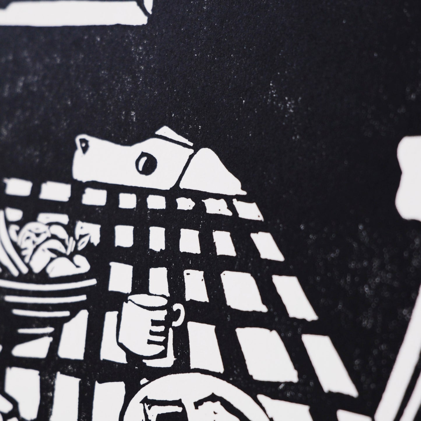 Black and white illustration of a table setting on with a dog eying up some leftovers - close up