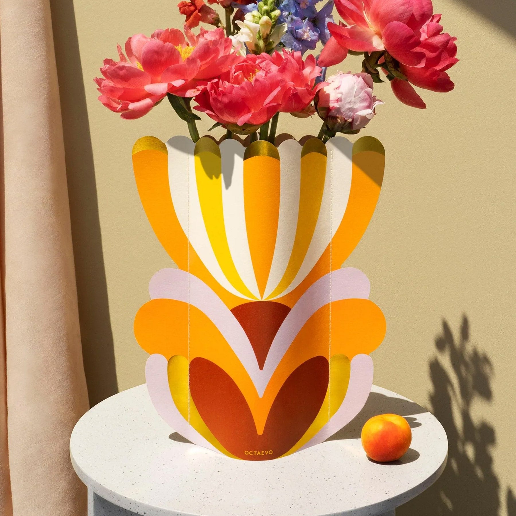 Colourful decorative paper vase in an abstract flower design sitting on table