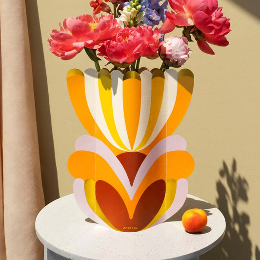 Colourful decorative paper vase in an abstract flower design sitting on table
