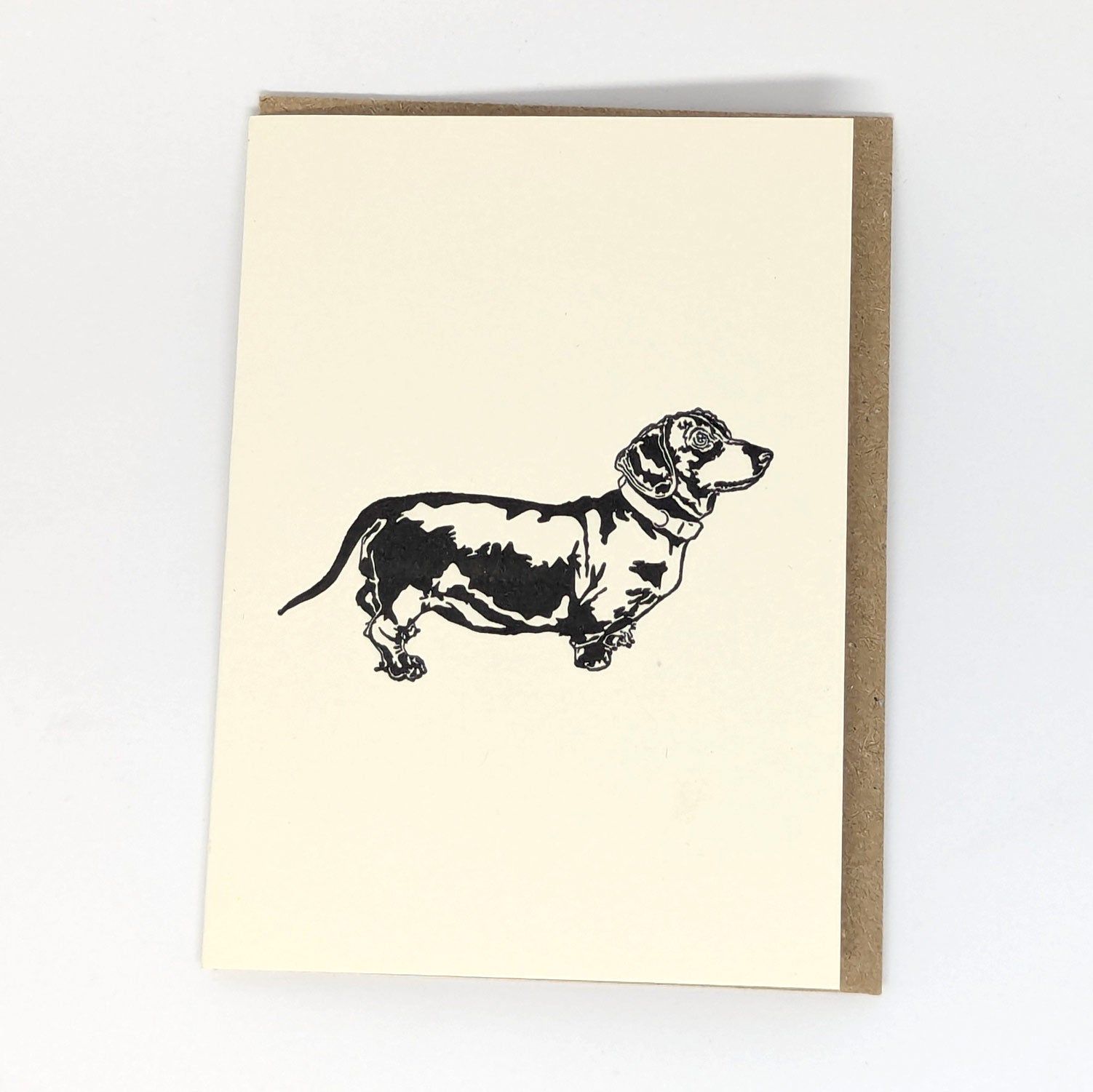 A greeting card with a letterpress illustration of a Dachshund dog.
