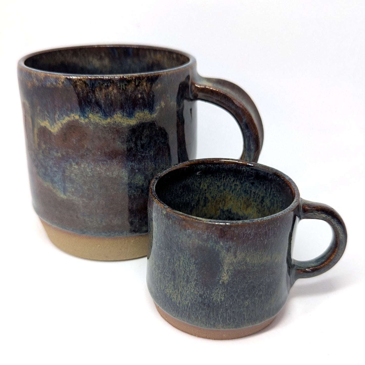 Two handmade mugs in dark blue and olive tones