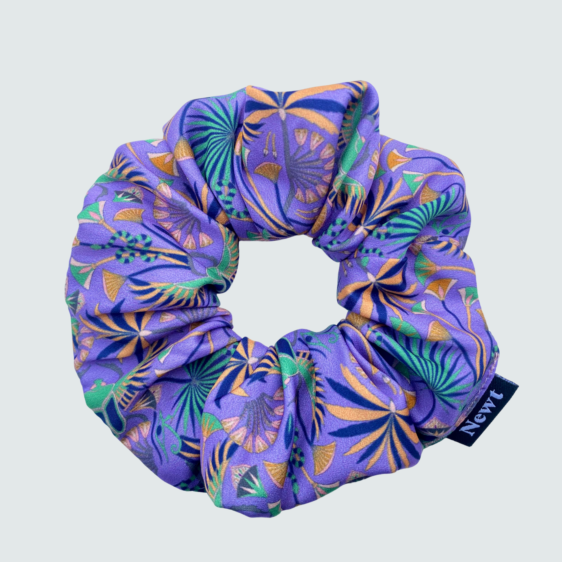 Purple scrunchie with pattern on a light gray background