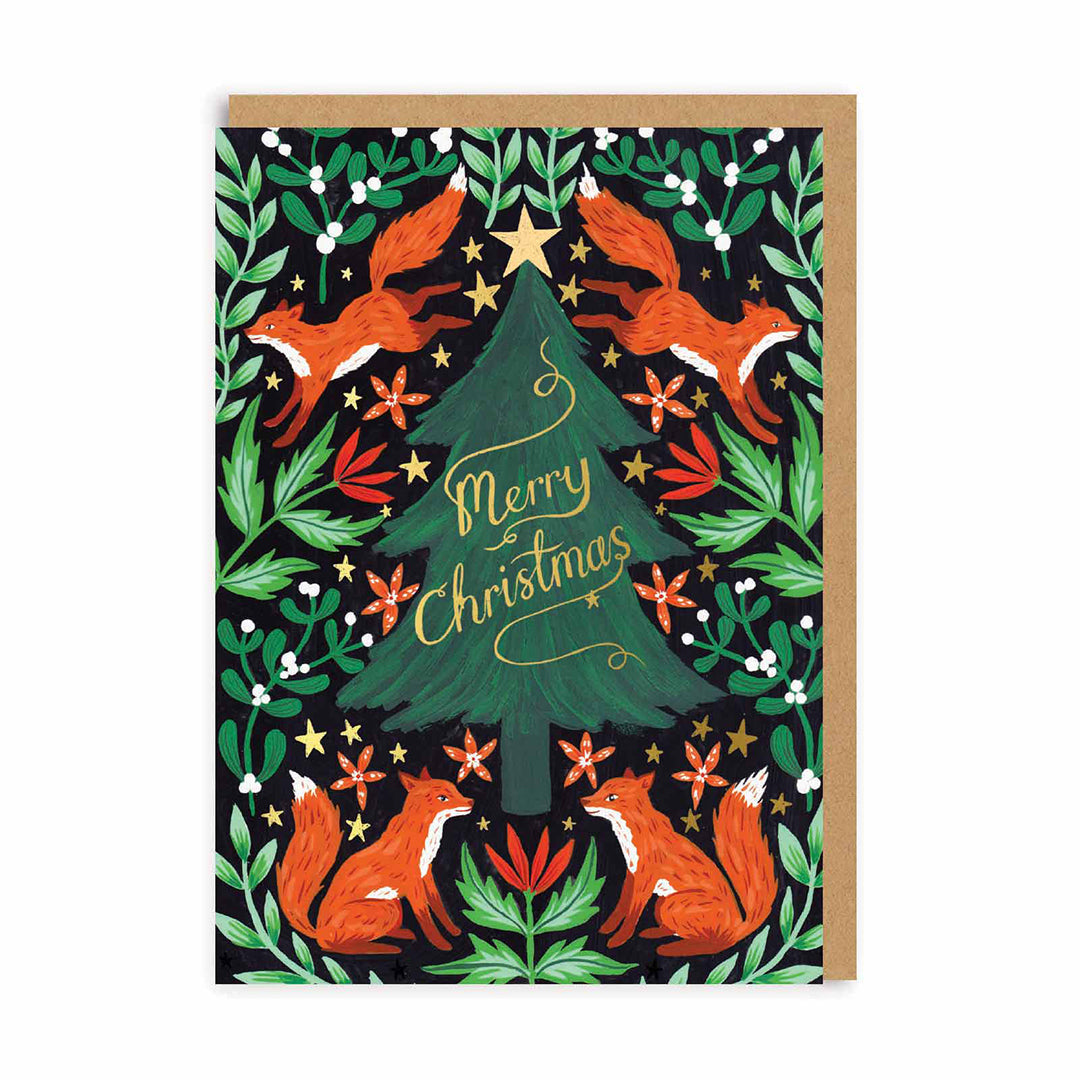 A beautifully illustrated greeting card of foxes and foliage surrounding a christmas tree in the centre with gold foil stars and lettering that reads ' Merry Christmas'