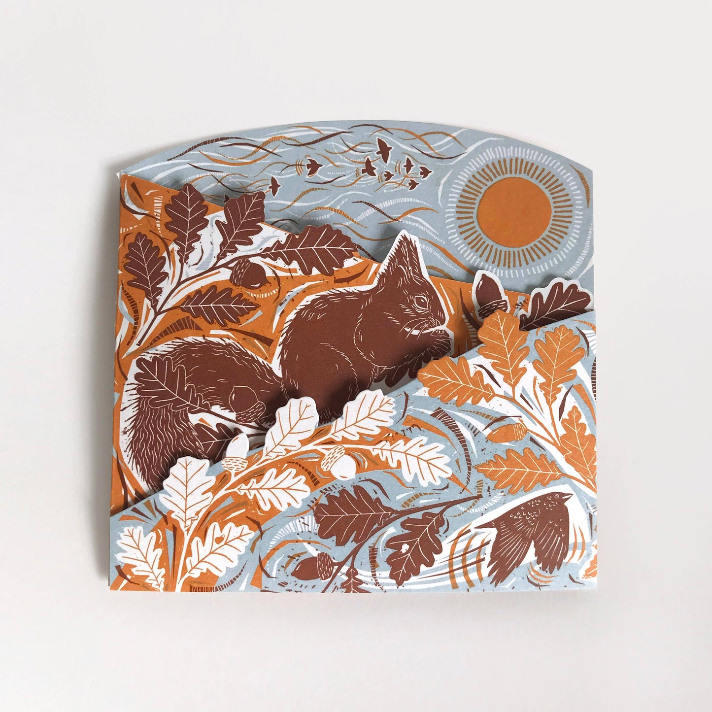 A concertina card featuring a red squirrel design