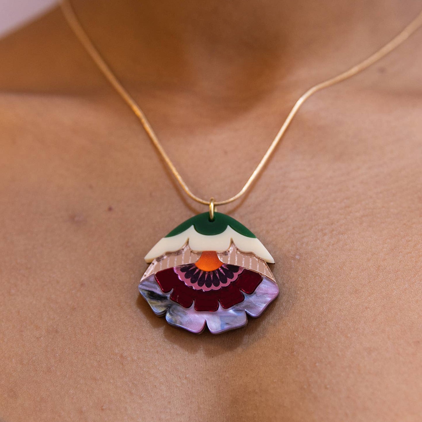 Necklace with a colorful pendant on a person's neck