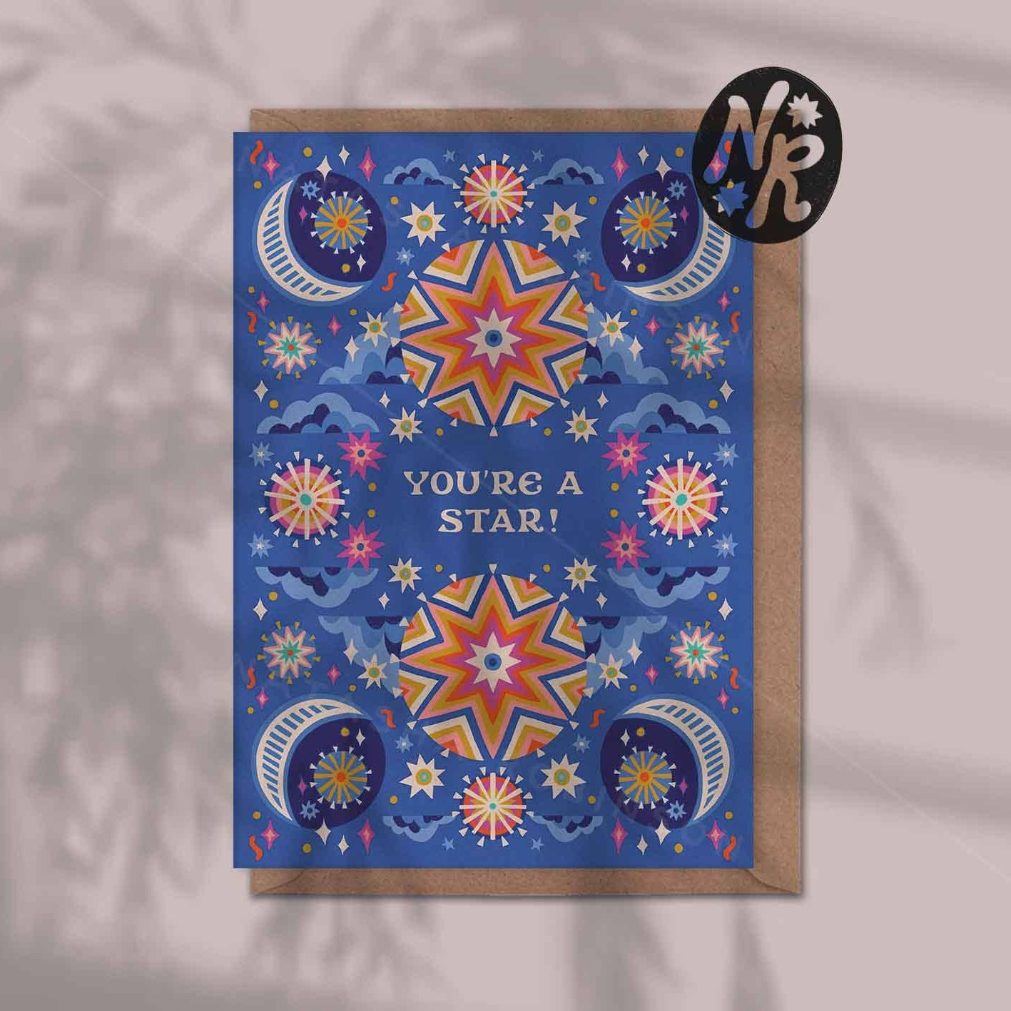 Greeting card with star and moon designs on a blue background, featuring the text 'You're a Star!'.