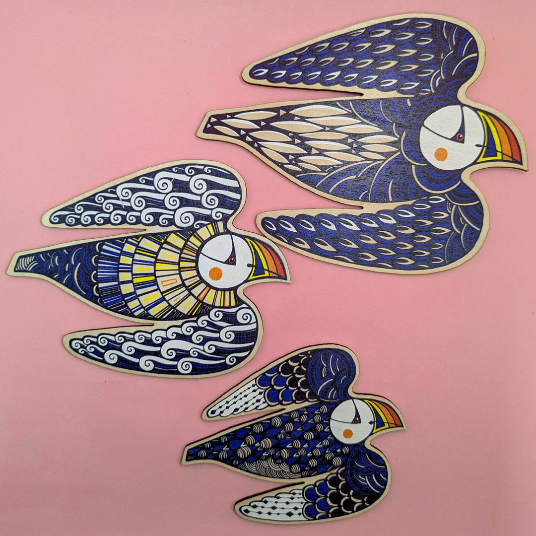 Three decorative puffin wall hangings