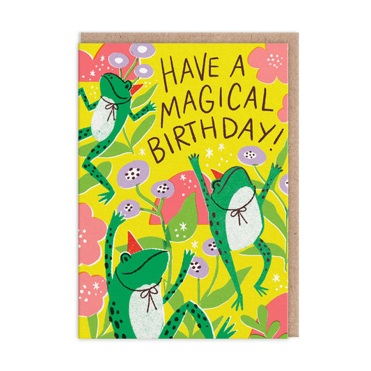 happy dancing frogs in birthday hats dance against a background of colourful flowers with the words 'have a magical birthday'