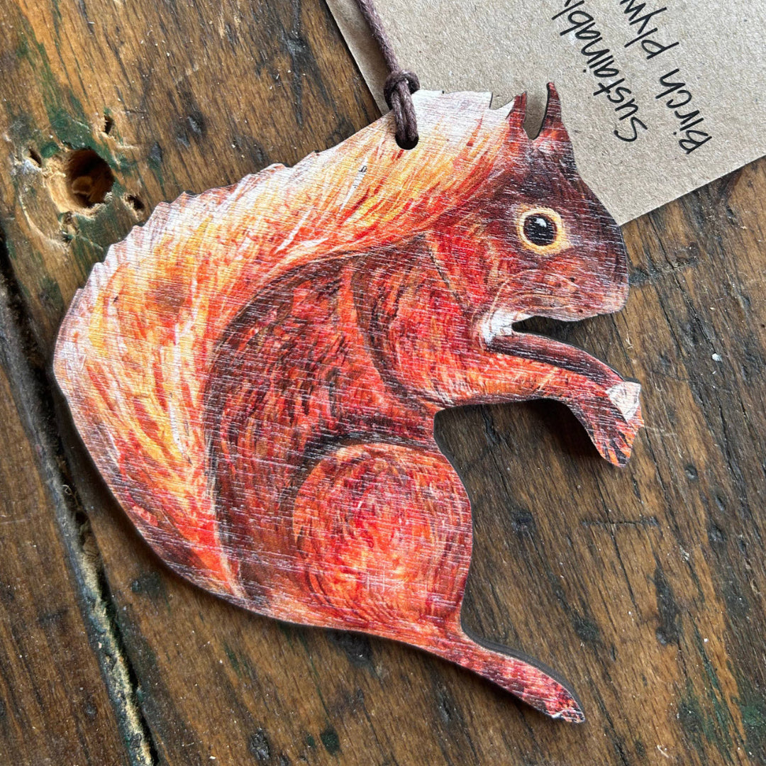 Wooden squirrel ornament on a rustic wooden surface