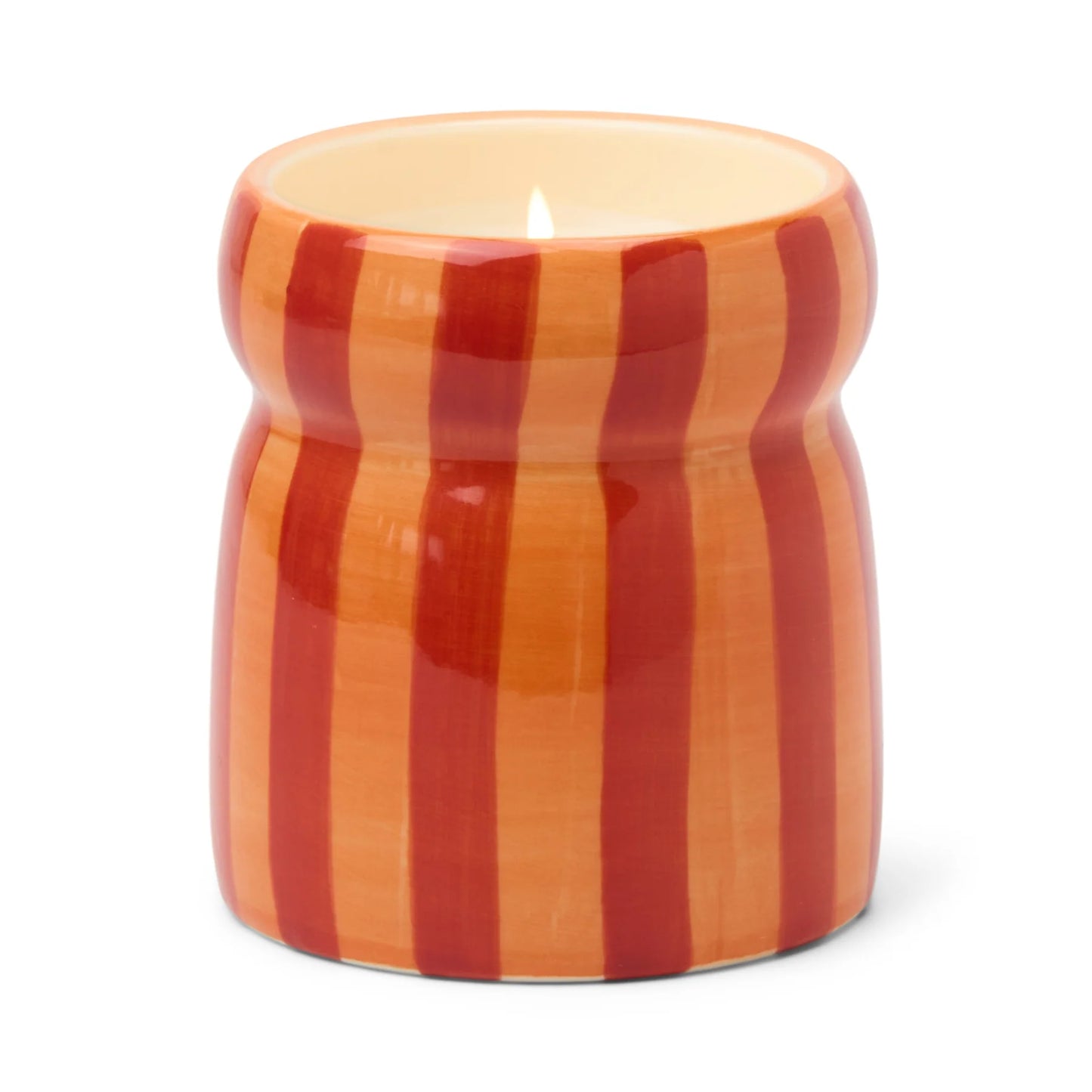 Candle in a striped orange and red ceramic container on a white background