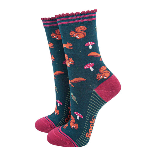 Pair of socks with red squirrels and mushroom pattern on a white background