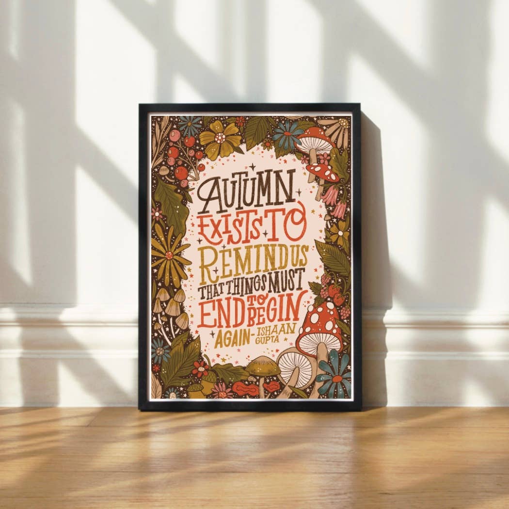 Framed autumn-themed print with decorative autumnal elements.