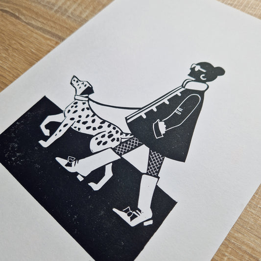 A black and white linocut print of a woman walking a dalmatian on a leash.
