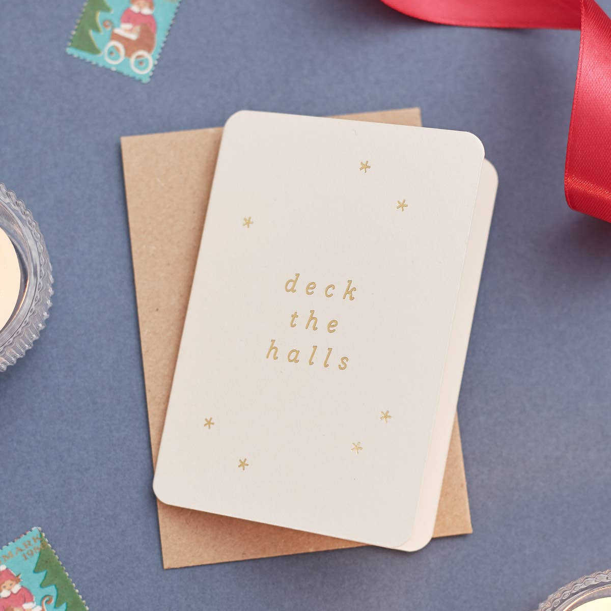 Christmas card with 'deck the halls' gold foil text