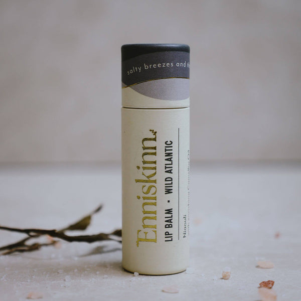 A stick of Enniskinn lip balm with the text 'LIP BALM - WILD ATLANTIC' and the brand's logo on the front. 