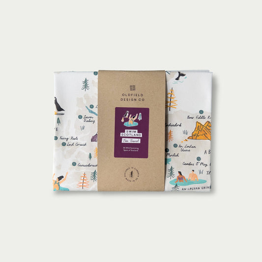Packaged and folded 'Swim Scotland' tea towel on white background