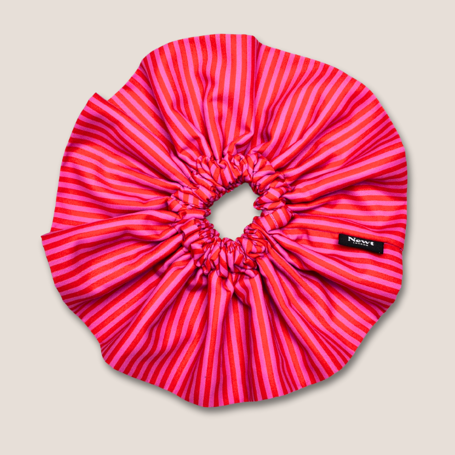 Pink striped scrunchie on a beige background