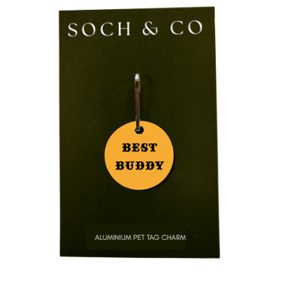 Yellow 'Best Buddy' pet tag charm on a black card with 'SOCH & CO' branding.