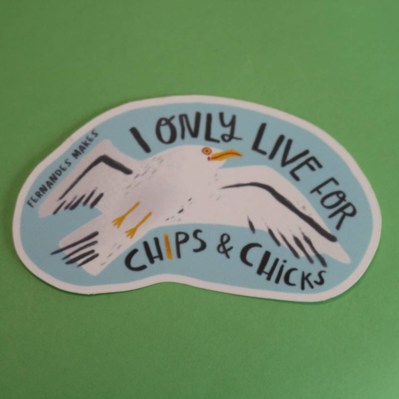 Sticker with a seagull and text 'I only live for chips & chicks' on a green background