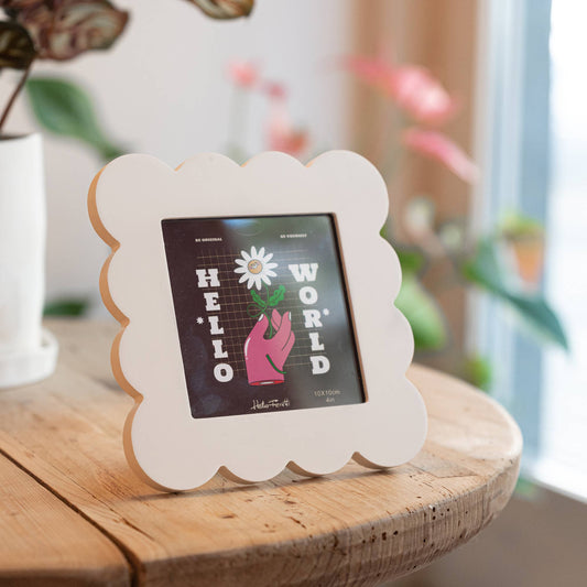 Cream scalloped  photo frame on a wooden surface