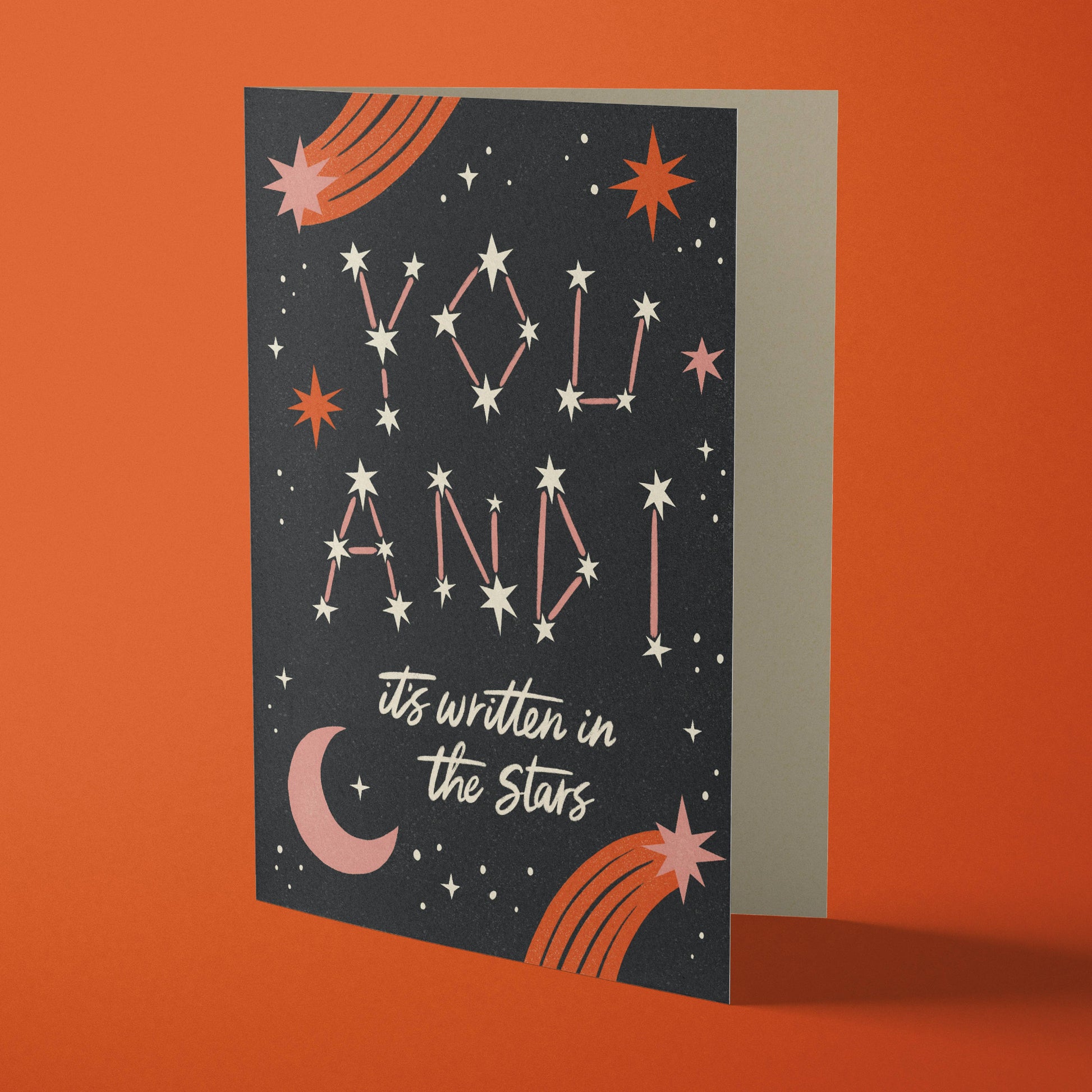 The words 'you and I' spelled out in stars on a card with moons and stars