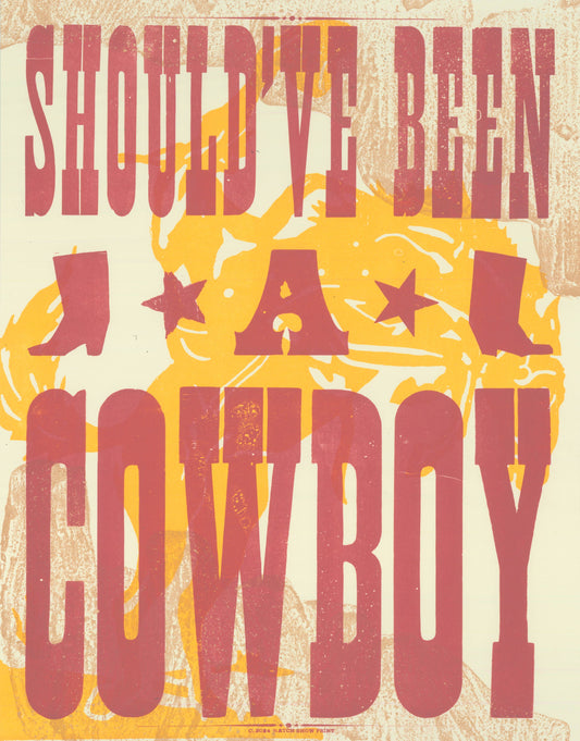 A poster with the title 'Should've Been A Cowboy' featuring letterpress printed text in red and yellow on a beige background with star imagery.