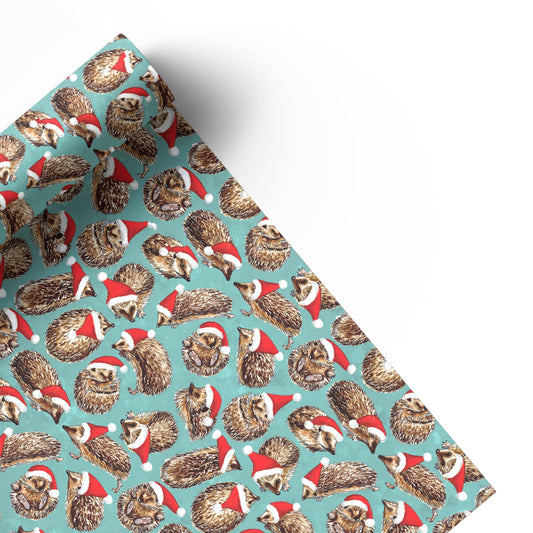 Wrapping paper with hedgehog pattern wearing Santa hats on a blue background