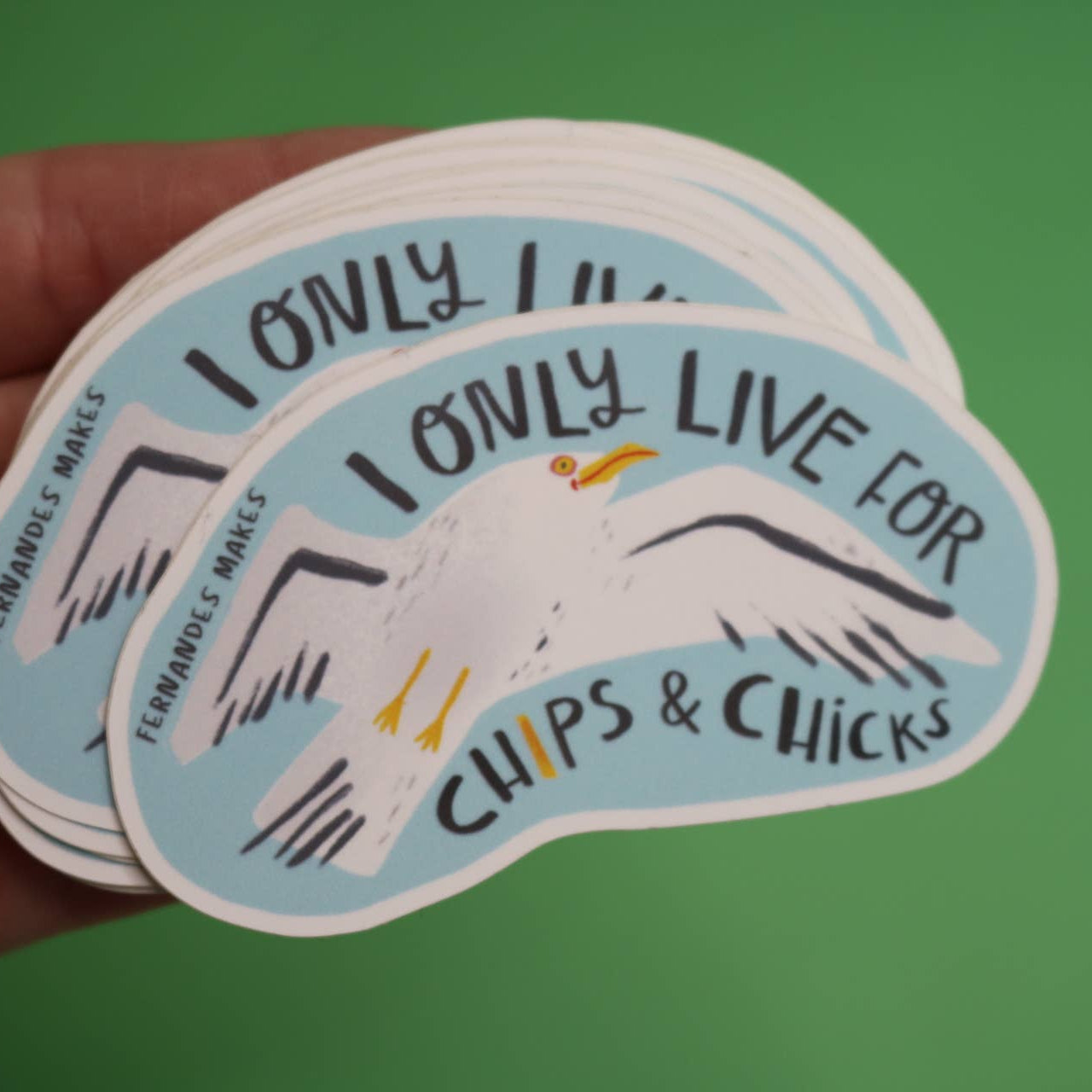 Sticker with a seagull and text 'I only live for chips & chicks' on a green background