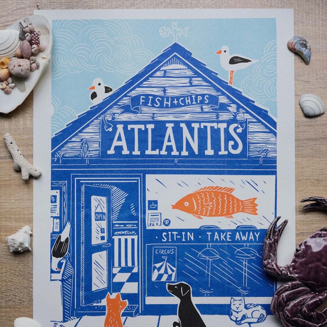 Illustration of a fish and chip shop named 'Atlantis' on a blue background with seagulls and sea-themed decor.