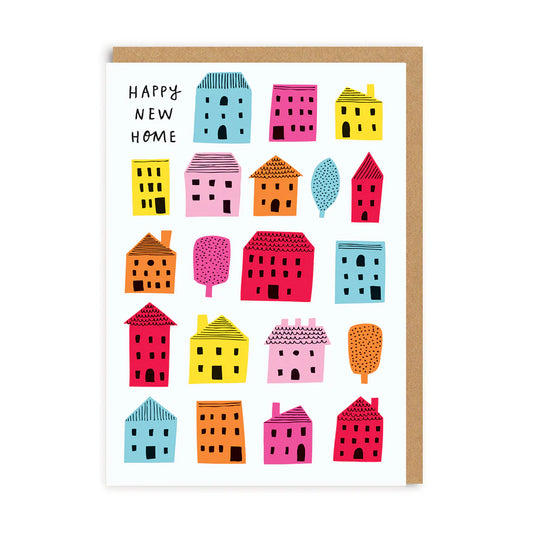 A greeting card with colorful illustrated houses and the text 'HAPPY NEW HOME' across the top. The card is accompanied by a Kraft envelope.