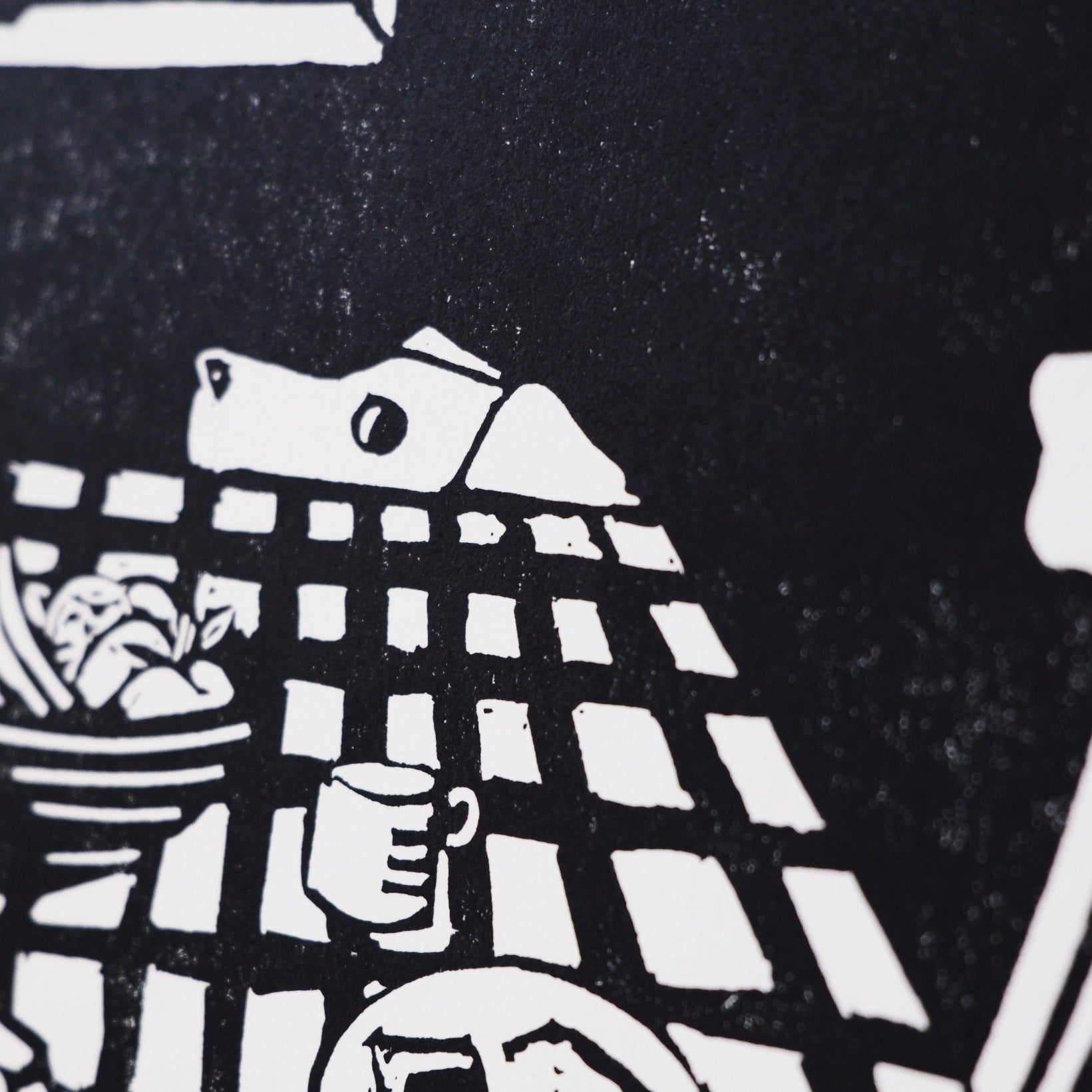Black and white illustration of a table setting on with a dog eying up some leftovers - close up