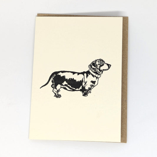 A greeting card with a letterpress illustration of a Dachshund dog.