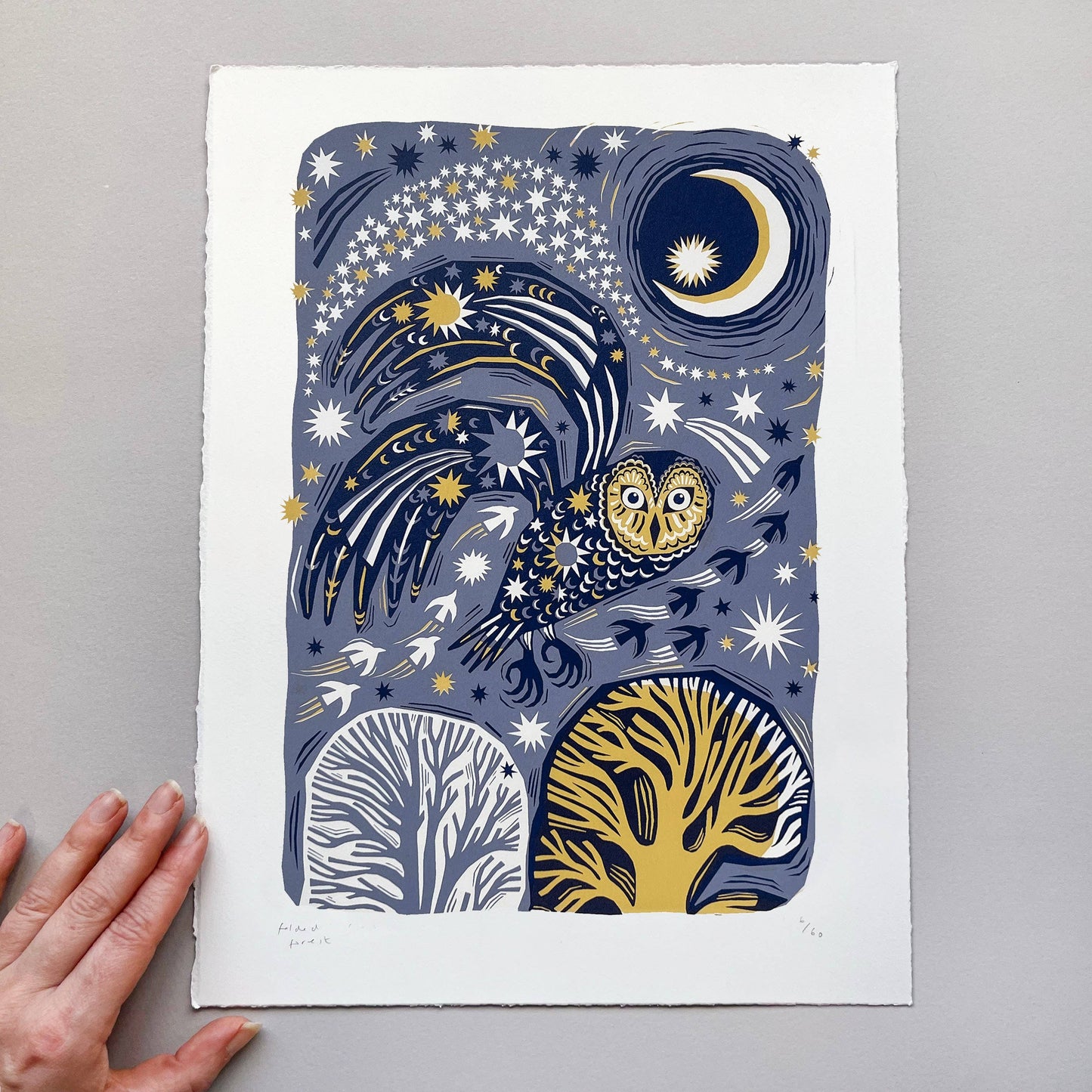 Art print with celestial design featuring an owl, trees, and stars on a gray background.