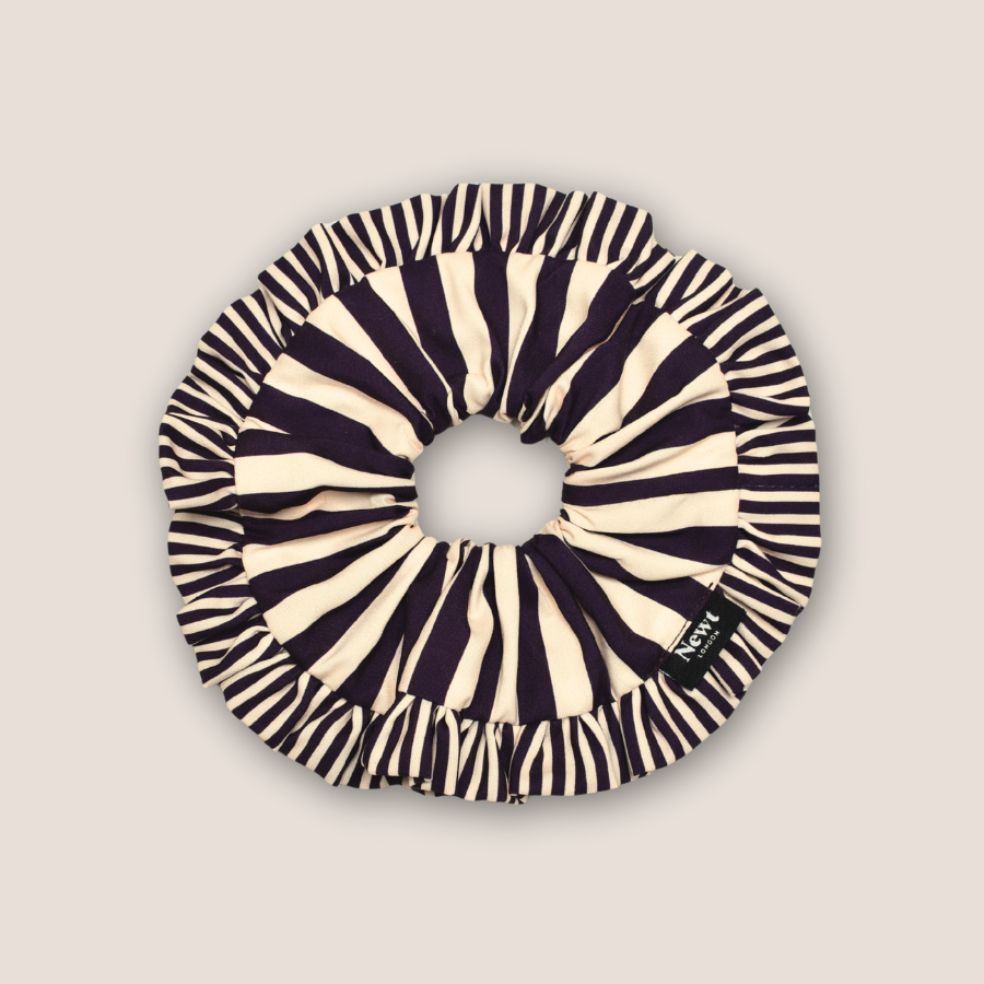 Black and white striped scrunchie on a beige background