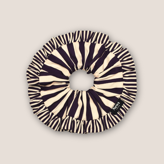 Black and white striped scrunchie on a beige background