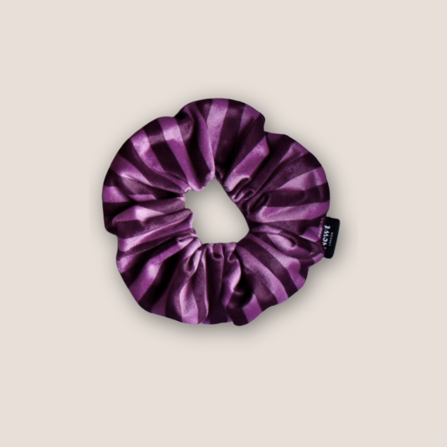 Purple striped scrunchie on a beige background