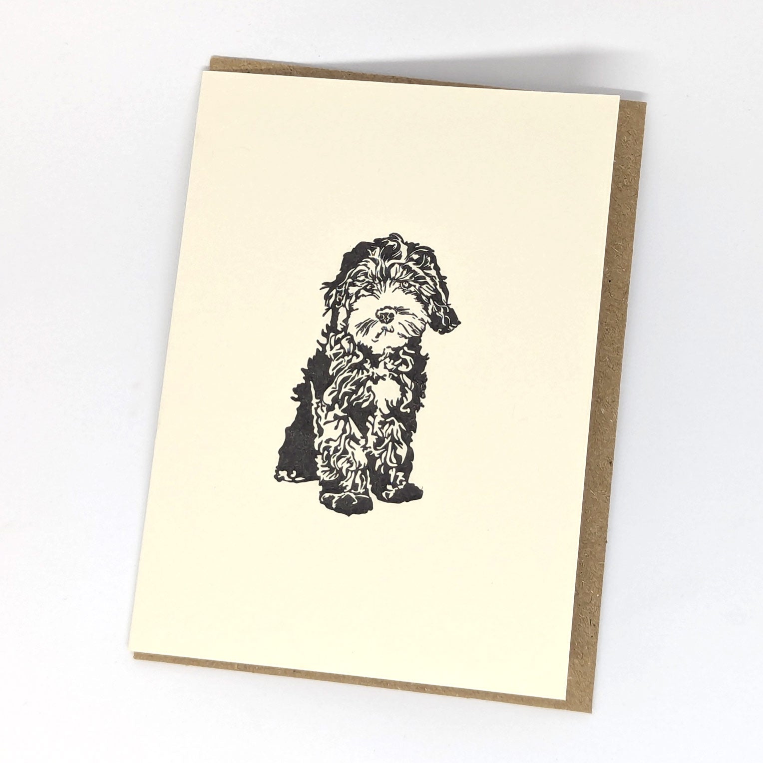 A greeting card with a black and white print of a Cockapoo dog.