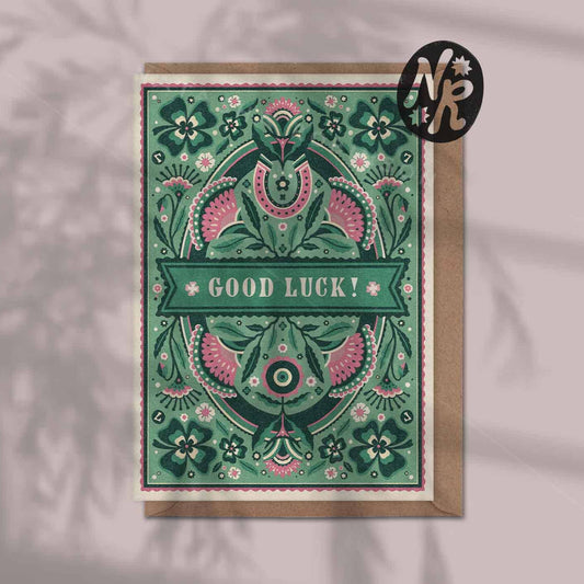 Decorative 'Good Luck!' card with intricate patterns in green and pink 