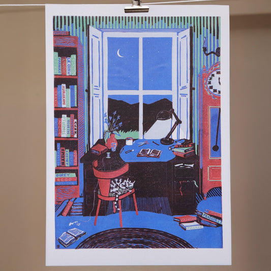 A colorful illustration of a library scene with a cat on a chair, books, and a desk lamp, looking out to a night sky.