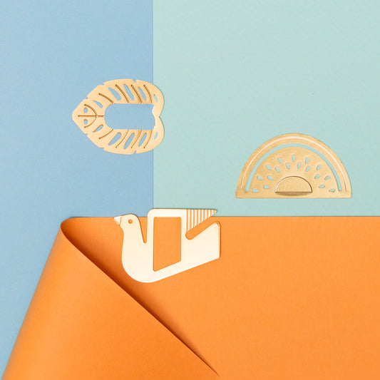 Decorative metal cutout paperclips on a split blue and orange background