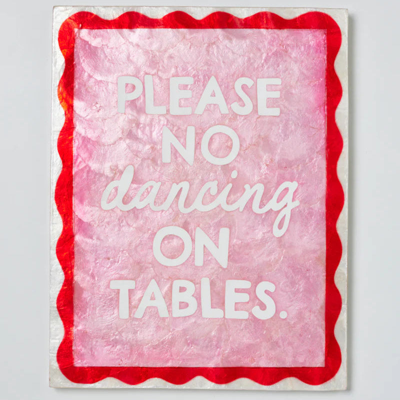 Sign with 'Please no dancing on tables' text on a pink background with red border.