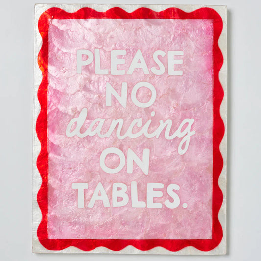 Sign with 'Please no dancing on tables' text on a pink background with red border.