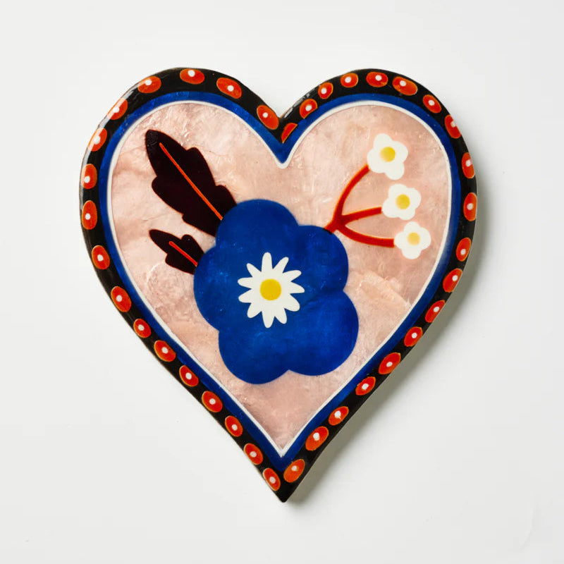 Heart-shaped capiz shell tile with floral design on a white background