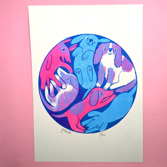 A blue and pink print of a group of pup[pies gathered in a circle.